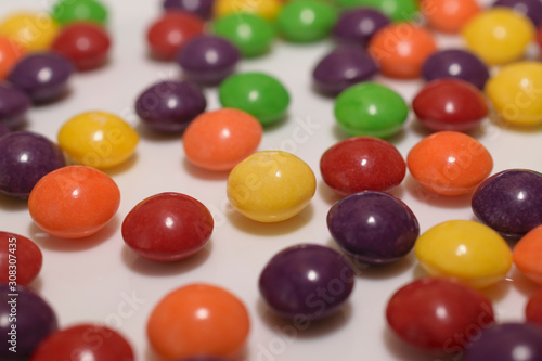 Close-up of multi-colored, round sweets. © Tauhavladi