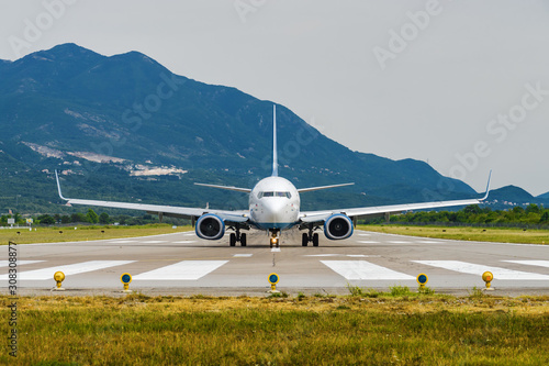 Sunny view of airplane taking off from airport of Tivat, Montenegro.