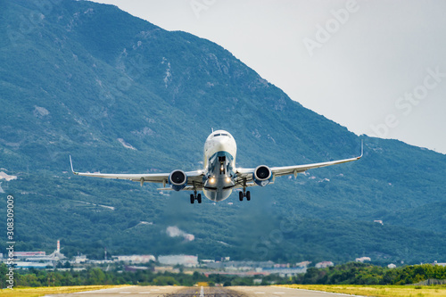 Foto Sunny view of airplane taking off from airport of Tivat, Montenegro