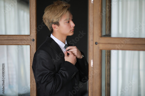 Young Asian businessman in white shirt and tie