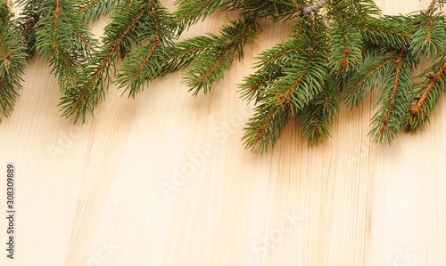 Christmas tree on wooden background.