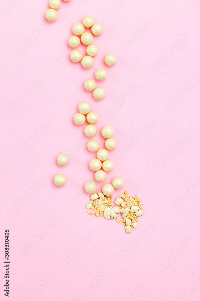 Beauty products blusher balls pearls on pink background. Vertical. Flat lay Beauty products blusher balls pearls on pink background. Vertical. Flat lay