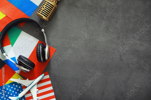 Learning foreign languages. Audio language courses. Background from countries flags and headphones on the table. photo