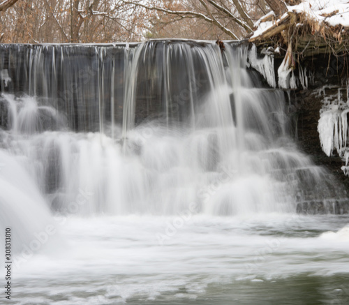 Small steps on a winter waterfall river