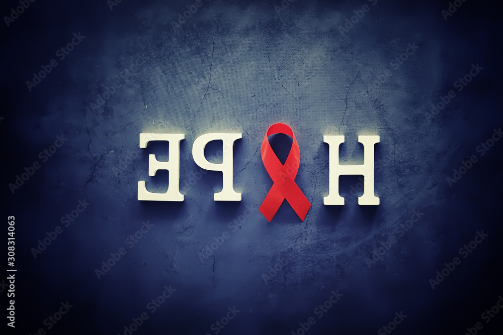 Symbol of human immunodeficiency virus disease. Red ribbon. A helping hand and support. Symbol of human immunodeficiency virus disease. Red ribbon. A helping hand and support.