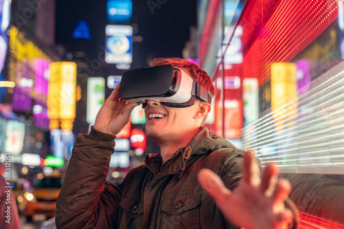 young man using VR in the city of new york