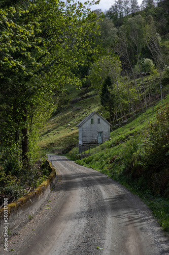 road in mountains and house in the mountains
