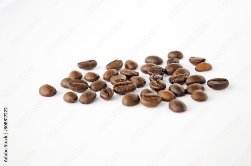 Coffee beans isolated on the white background. Grains of coffee close-up. Selective focus Coffee beans isolated on the white background. Grains of coffee close-up. Selective focus