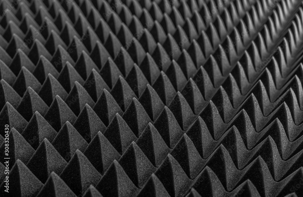 Abstract background in the form of pyramids and dragon scales. Acoustic black foam rubber. Abstract background in the form of pyramids and dragon scales. Acoustic black foam rubber.
