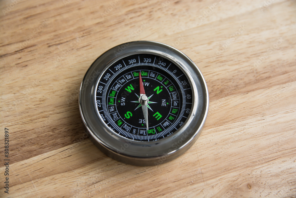 Compass on a wooden surface. Compass on a wooden surface.