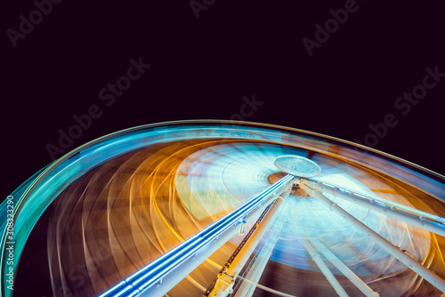 Moving and illuminated ferris wheel  big  wheel on a dark background.