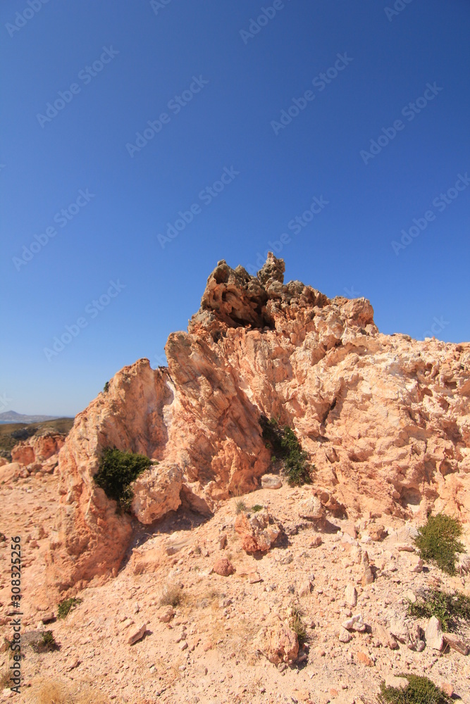 Volcanic rocky red cliffs in Milos, Greece Volcanic rocky red cliffs in Milos, Greece