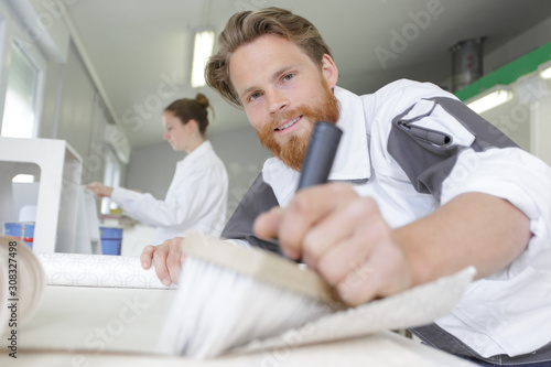 contractor worker preparing for wallpaper decoration