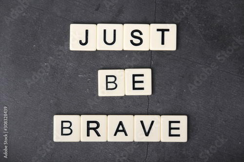 A motivational quote Just be brave formed with tile letters  © nastyakamysheva