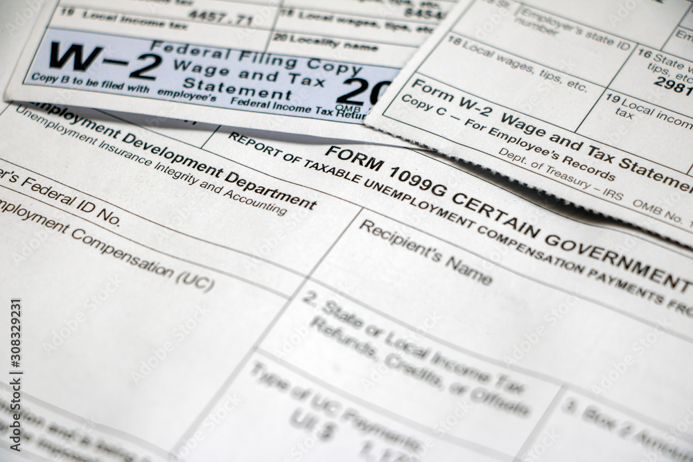Closeup of overlapping tax forms, 1099G and W-2 Closeup of overlapping tax forms, 1099G and W-2