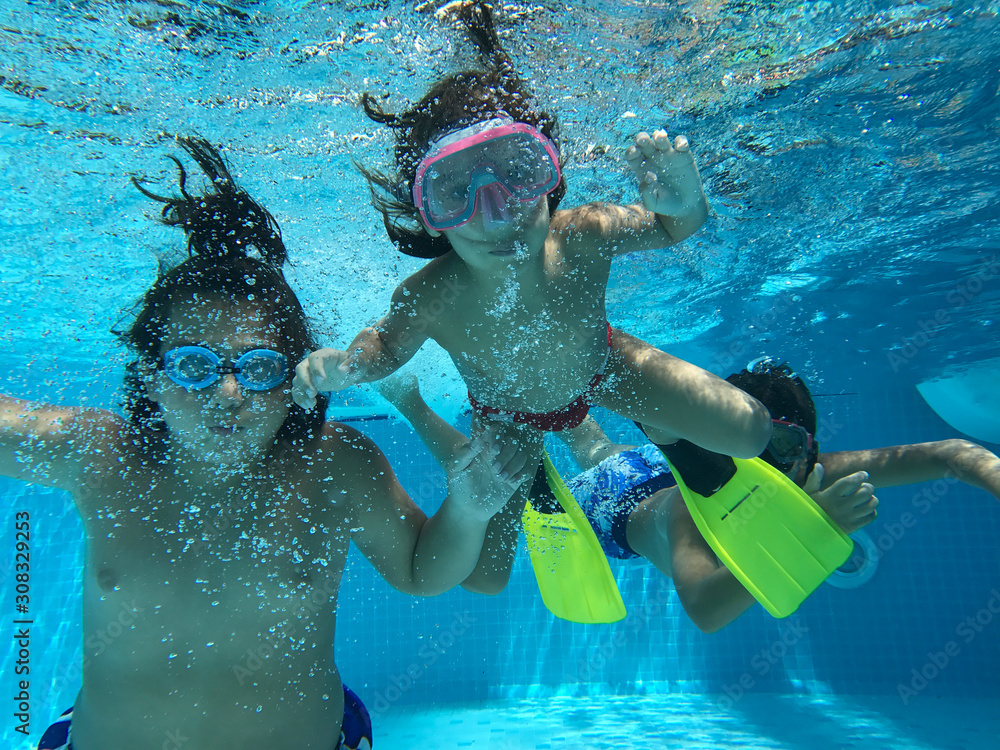 Children enjoying in pool underwater
