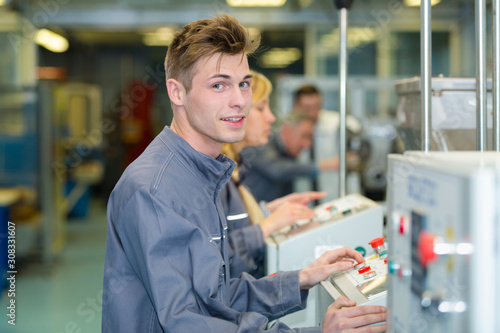 Canvas Print young male factory machine operator
