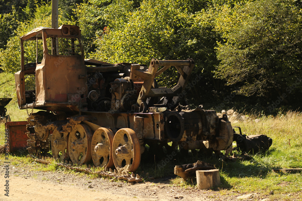 Obraz premium HDR image of old rusty tractor in a field.