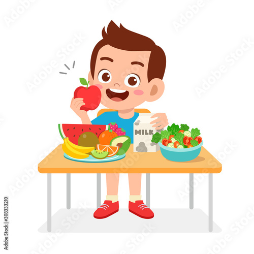 happy cute kid boy eat healthy food