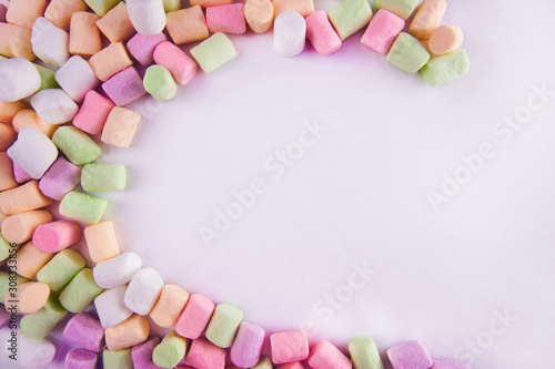 marshmallows on a white isolated background in the shape of a crescent. multicolored sweets.