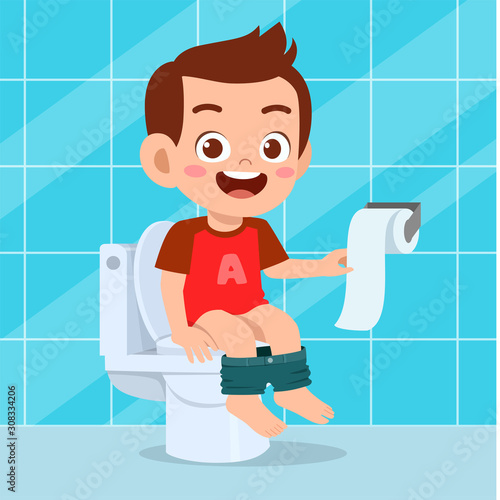 happy cute kid boy sit on the toilet