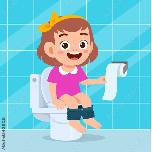 happy cute kid girl sit on the toilet