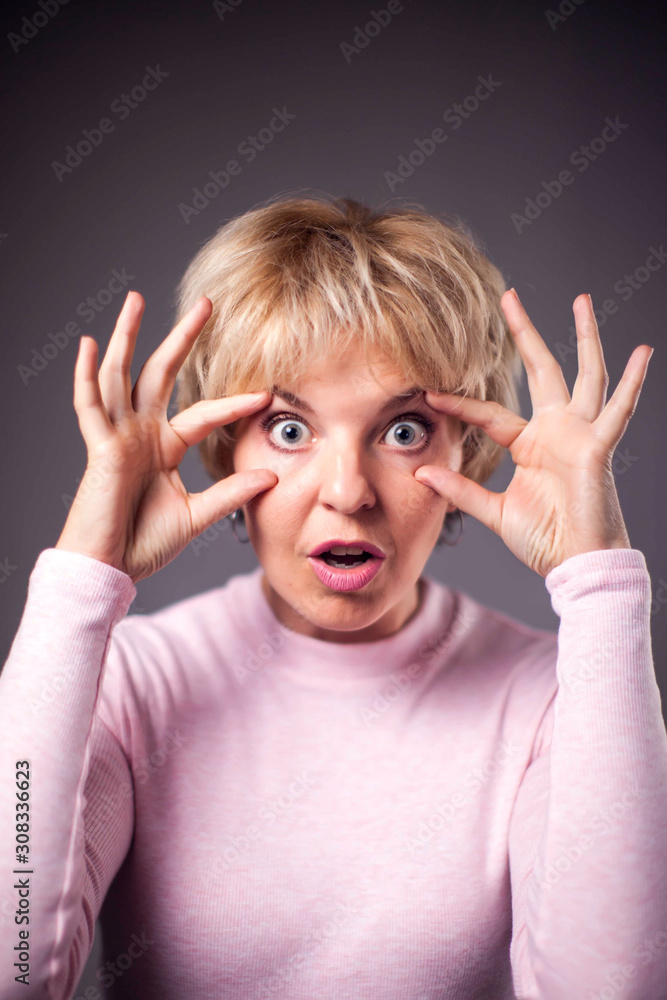 Woman with blond hair with surprised face. People and emotions concept Woman with blond hair with surprised face. People and emotions concept
