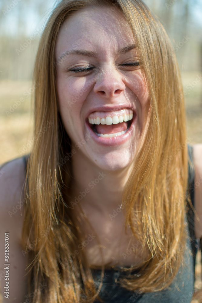 portrait of a young woman lauhging portrait of a young woman lauhging