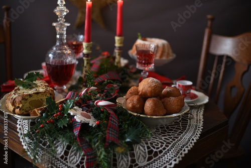 Decorated Christmas table with deep fried doughnut balls. Christmas in Holland.