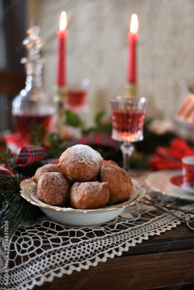 Decorated Christmas table with deep fried doughnut balls. Christmas in Holland. Decorated Christmas table with deep fried doughnut balls. Christmas in Holland.