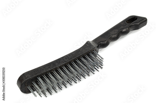 Steel wire brush with handle from black plastic for cleaning and polishing hard or metal equipment, isolated on white background