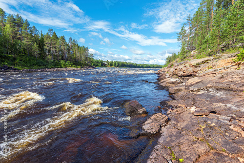 The water course of Ounasjoki – Molkojoki river bordered by pin forests in Finnish Lapland. photo