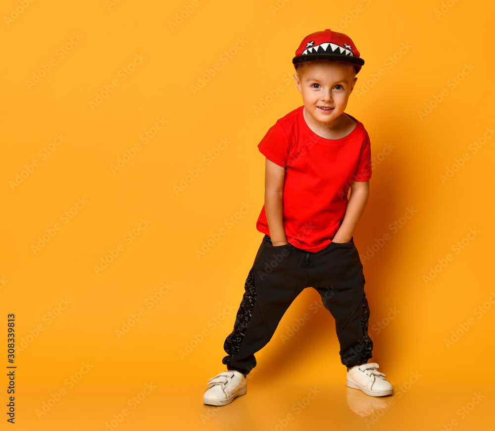Happy Smiling Handsome Man Dancing In Studio. Funny Joyful Indian Guy In Yellow  Shirt, Red Bowtie And Pants With Suspenders Dancing And Laughing Isolated  On Solid Yellow Color Copy Space Background Stock