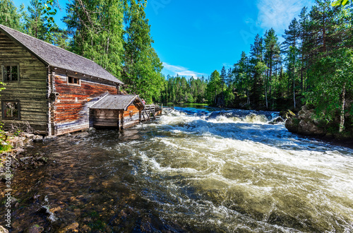 Wooden hut in the border of Yattumutka river in Myllykoski point of Pieni Karhunkierros Trail in Finish Oulanka National Park. photo