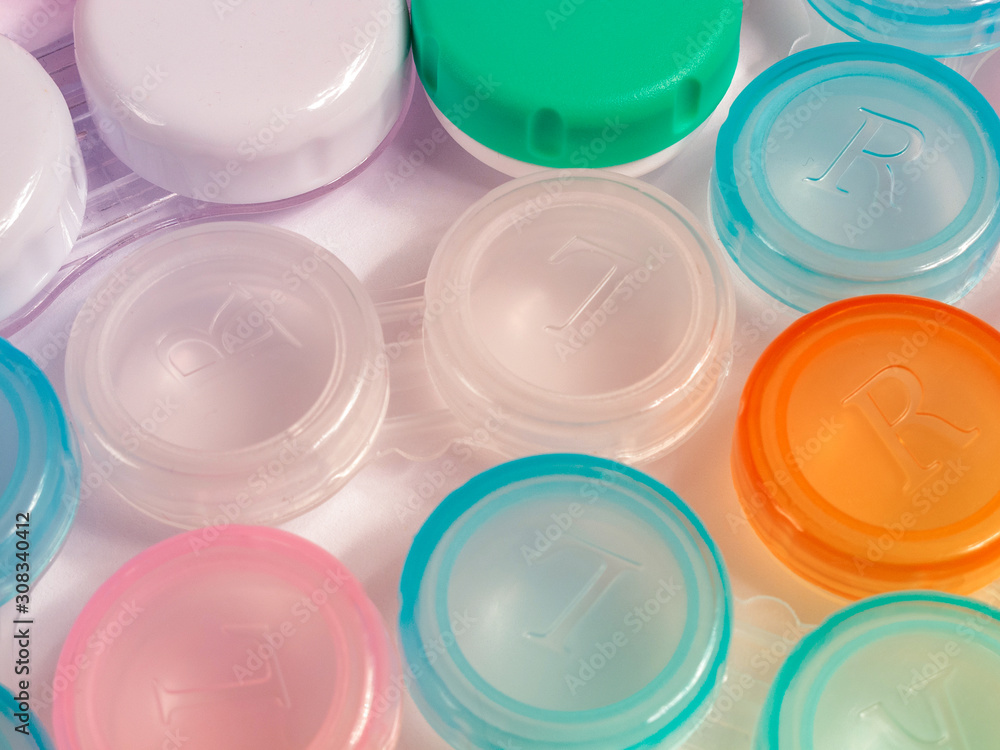 containers for soft contact lenses, multi-coloured, for cleaning and storage, close up containers for soft contact lenses, multi-coloured, for cleaning and storage, close up