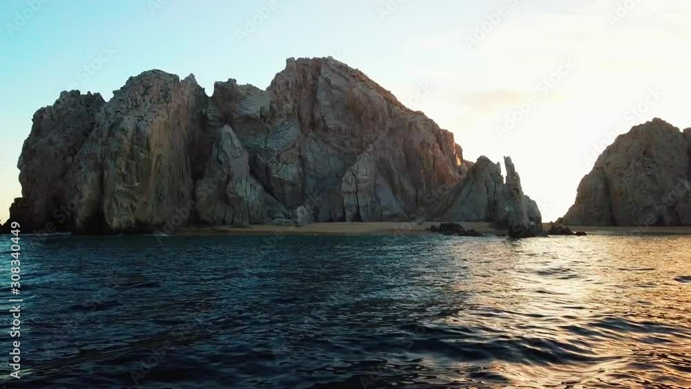 Beautiful sunset behind seascape cliffs on Mexican shoreline, view from sea Beautiful sunset behind seascape cliffs on Mexican shoreline, view from sea