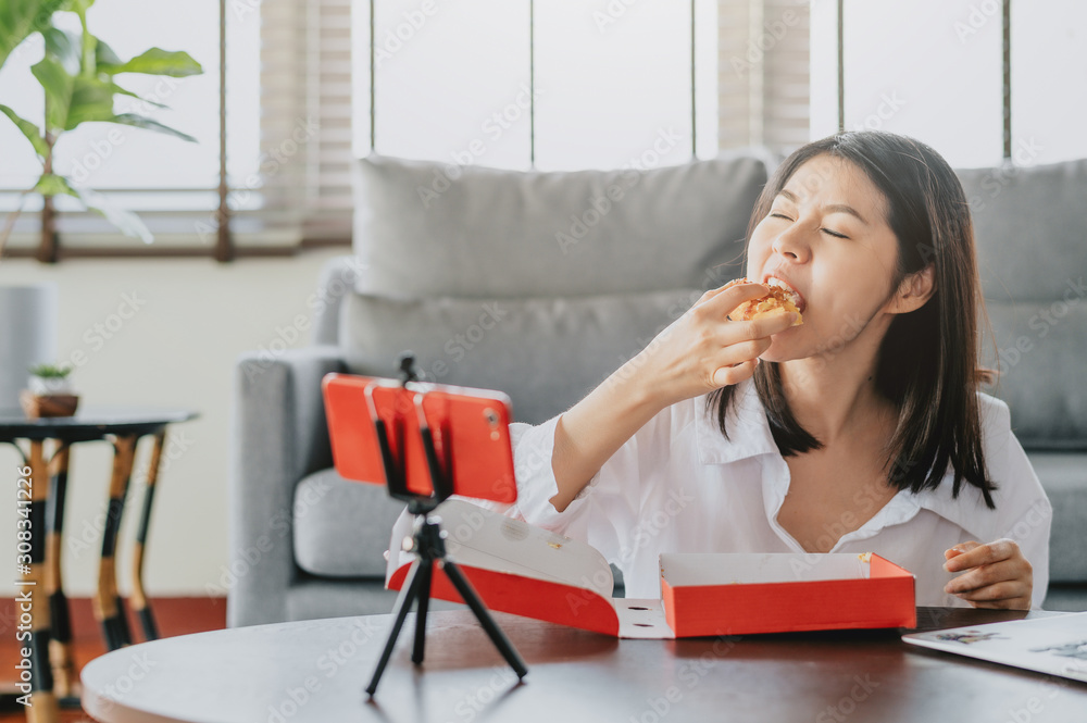 Woman food blogger eating pizza while creating new content video Woman food blogger eating pizza while creating new content video