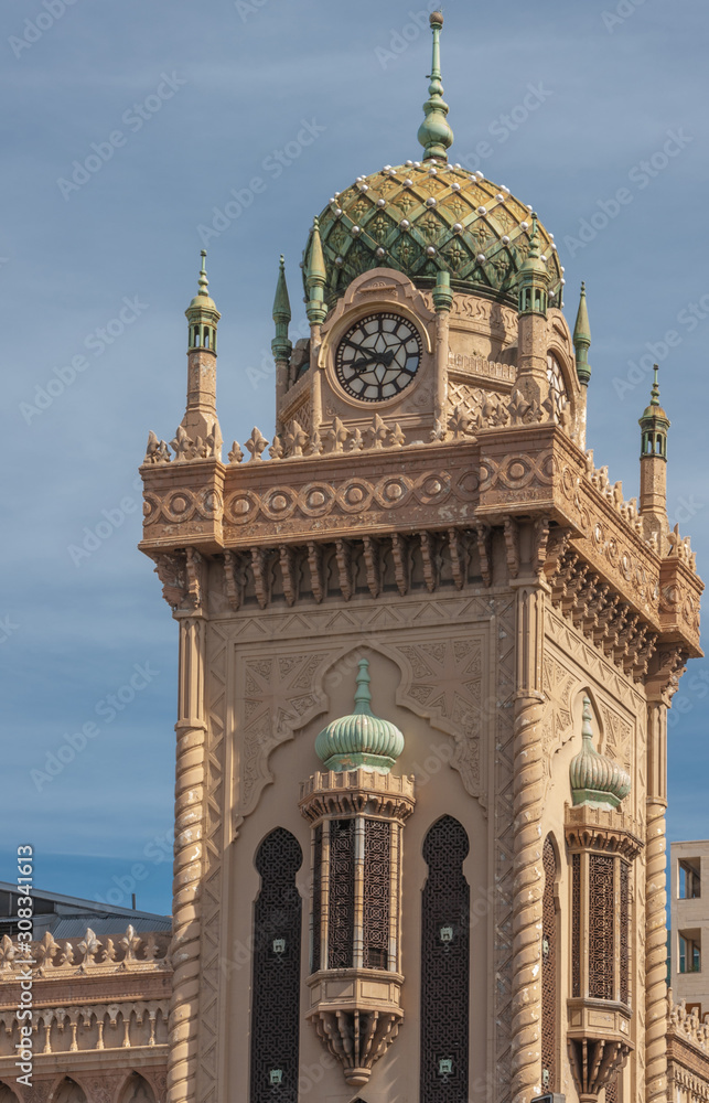 Melbourne, Australia - November 14, 2009: The beige stone with green dome clock tower of The Forum Theatre, built in Moorish revival architecture against blue sky.