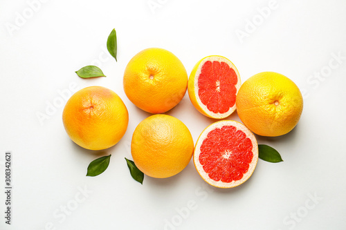 Fresh ripe grapefruits on light background