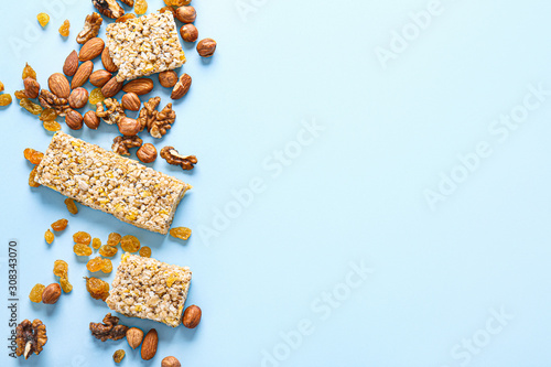 Tasty granola bars on color background