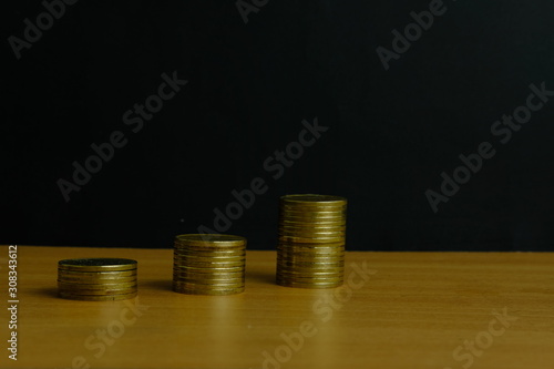 Stack of golden money coin on a wooden table