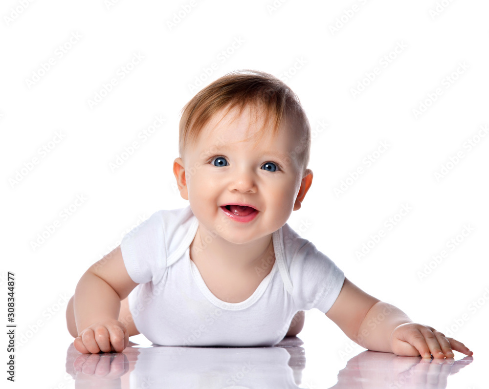 Infant child baby boy kid with blue eyes happy smiling screaming lying on a floor isolated on a white background Infant child baby boy kid with blue eyes happy smiling screaming lying on a floor isolated on a white background
