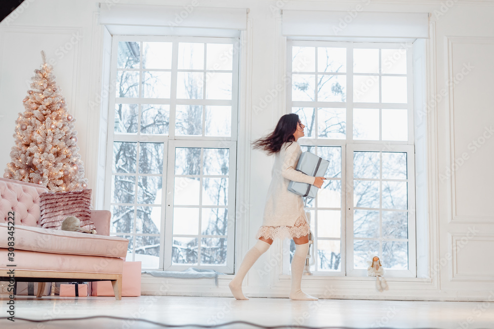 Beautiful young girl in white dress posing on camera. Christmas concept Beautiful young girl in white dress posing on camera. Christmas concept