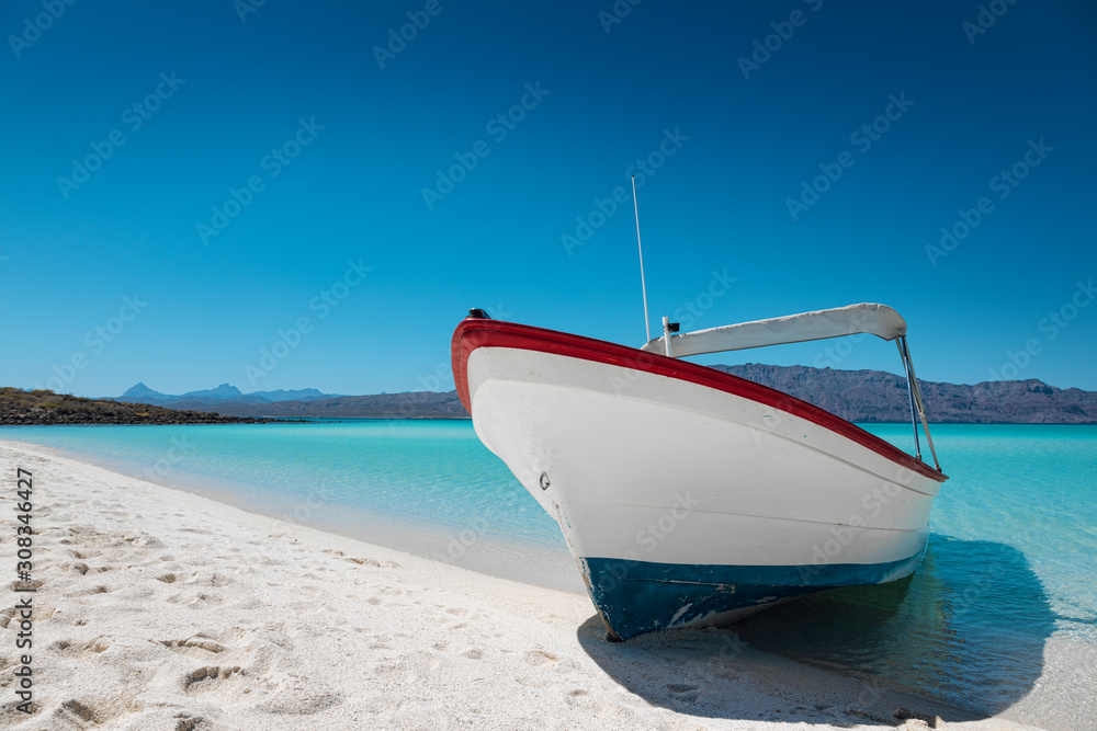 Motor boat at the paradise beach with white sand, turquoise sea and blue sky, Playa Isla Coronado, Mexico Motor boat at the paradise beach with white sand, turquoise sea and blue sky, Playa Isla Coronado, Mexico