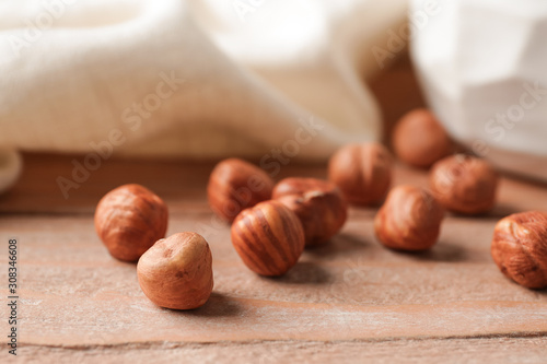 Tasty hazelnuts on wooden background