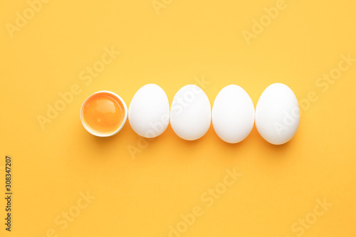 Broken egg among whole ones on color background. Concept of uniqueness