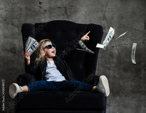 Εκτύπωση καμβά Happy smiling rich kid girl millionaire sitting in expensive armchair with a bun