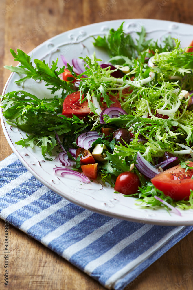 Salad with Olives, Tomatoes, Endive and Red Onion. Healthy Snack Idea. Rustic wooden background. Salad with Olives, Tomatoes, Endive and Red Onion. Healthy Snack Idea. Rustic wooden background.