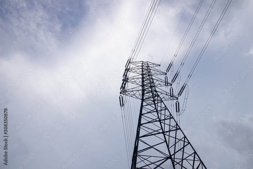 Utility pole supporting overhead power line cables against blue sky as copy space Utility pole supporting overhead power line cables against blue sky as copy space