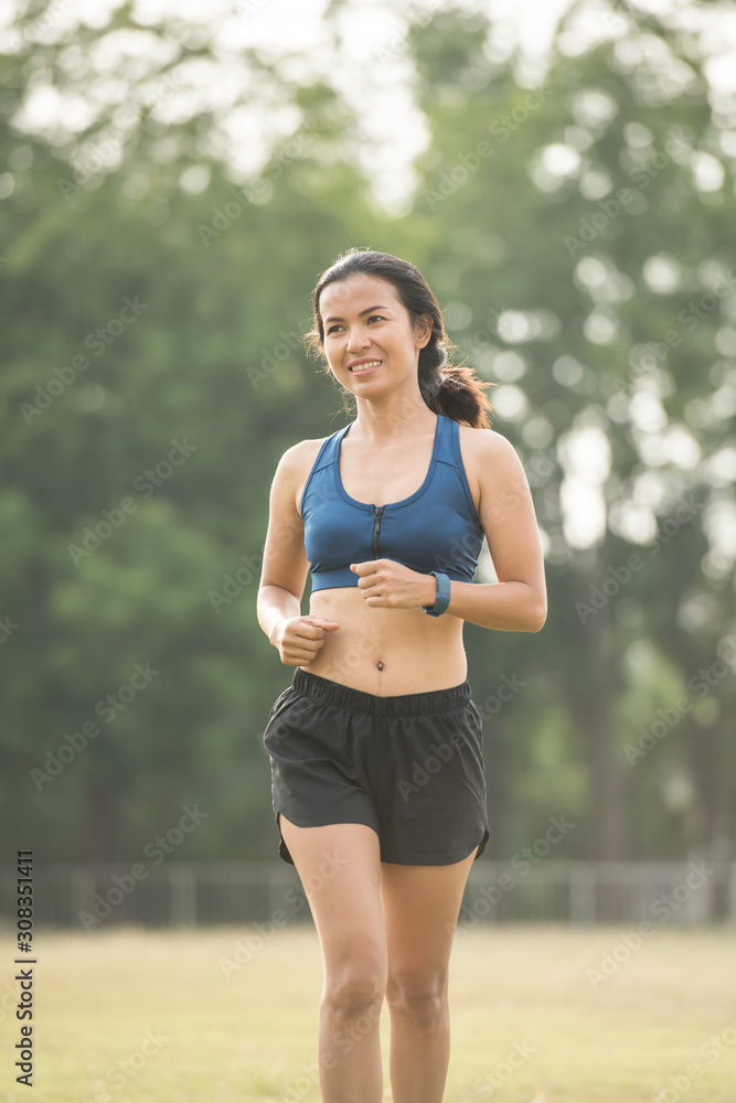 Pretty sporty woman jogging at park Pretty sporty woman jogging at park